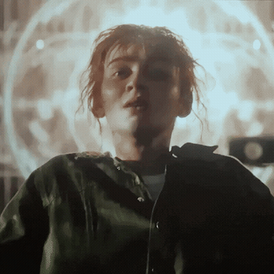 Redhead In Black Shirt And Tan Jacket GIF
