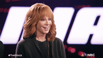 Redhead Smiling In Front Of NBC Logo GIF
