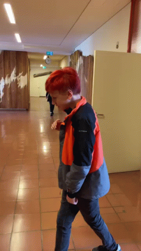 Redhead Walking Down Hallway In Columbia Jacket GIF