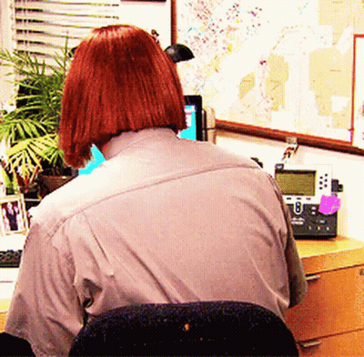 Redhead Woman At Desk With Telephone And Map GIF