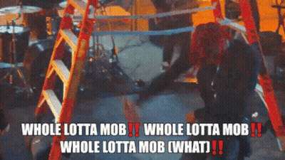 Redhead Woman Beside Ladder Says Whole Lotta Mob GIF