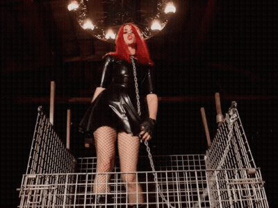 Redhead Woman Chained To Cage GIF