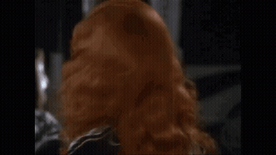 Redhead Woman In Black Dress Making Funny Face GIF
