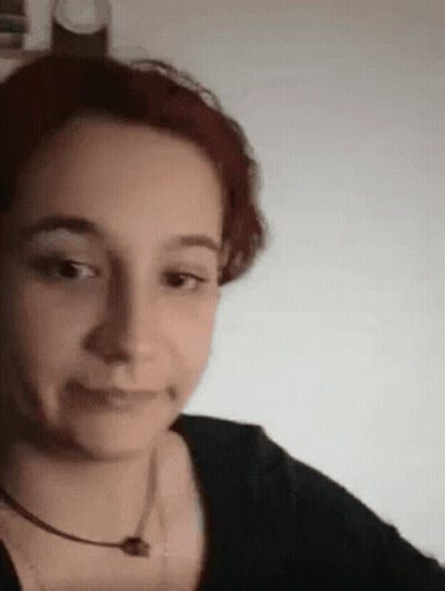 Redhead Woman In Black Shirt Making Funny Face GIF