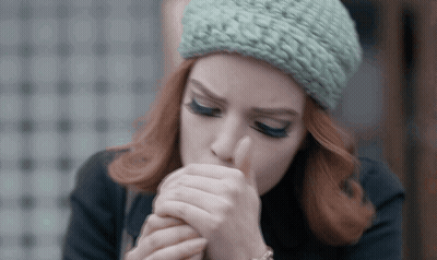 Redhead Woman In Green Knitted Hat Coughing GIF