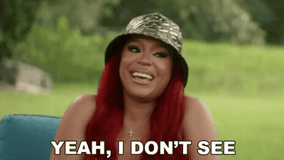 Redhead Woman In Hat Laughing On Couch GIF