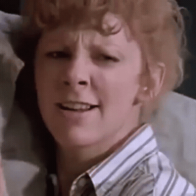 Redhead Woman In Striped Shirt Making Funny Face GIF