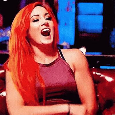 Redhead Woman Laughing On Red Couch GIF