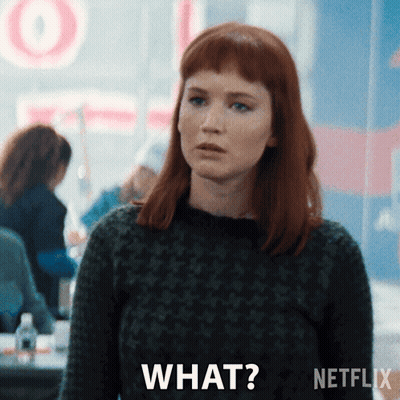Redhead Woman Saying What In Front Of Netflix Logo GIF