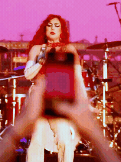 Redhead Woman Singing Into Microphone At Drum Set GIF