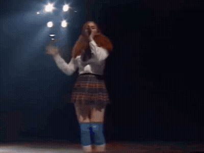 Redhead Woman Singing Into Microphone Dancing GIF