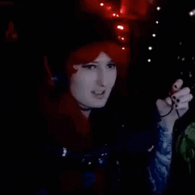 Redhead Woman Singing Into Microphone With Headphones GIF