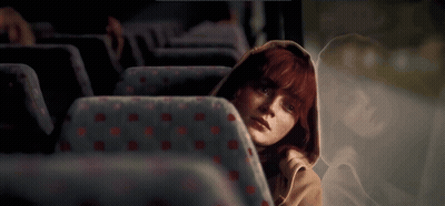 Redhead Woman Sitting In Bus With Reflection GIF