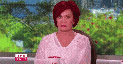 Redhead Woman Sitting With Coffee At Window GIF
