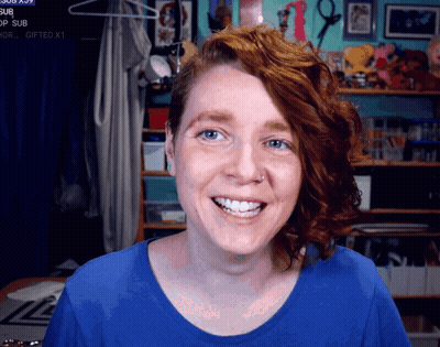 Redhead Woman Smiling At Gifted Sign GIF