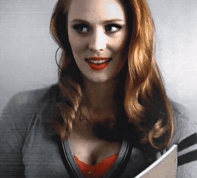 Redhead Woman Smiling Holding Book GIF