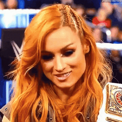 Redhead Woman Smiling With Championship Belt In Wrestling Ring GIF