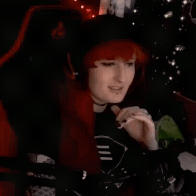 Redhead Woman Smoking In Chair By Christmas Tree GIF