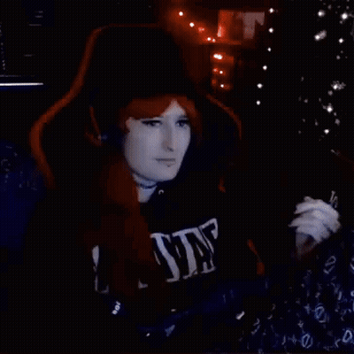 Redhead Woman Waving In Gaming Chair GIF