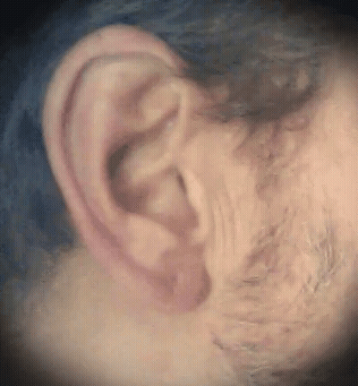 Redhead Woman With Pearl Necklace Hand To Ear GIF