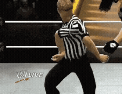 Referee Dancing In Wrestling Ring With W Live Logo GIF