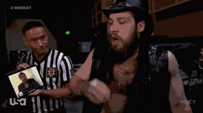 Referee Displays Photo To Second Wrestler GIF