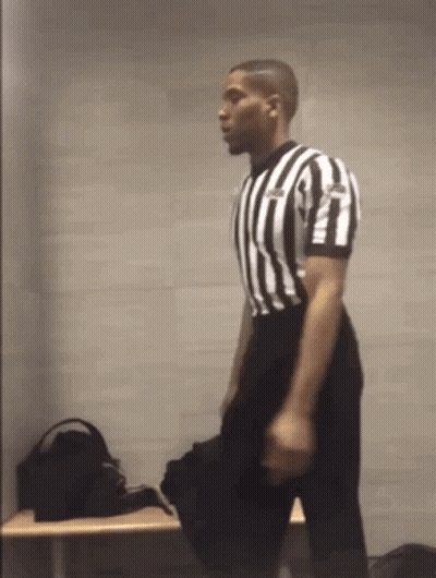 Referee In Black And White Striped Shirt Kneeling GIF