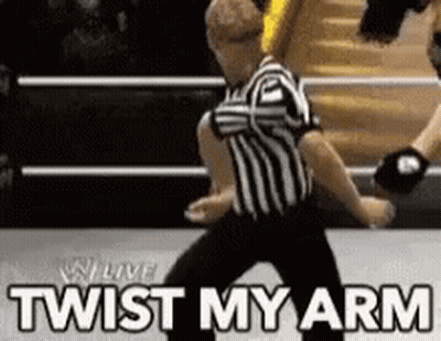 Referee In Wrestling Ring Saying Twist My Arm GIF