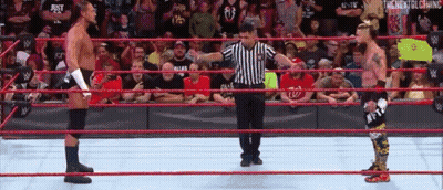 Referee In Wrestling Ring With Two Wrestlers GIF