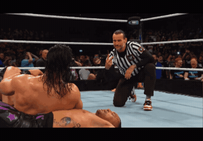 Referee Kneeling Over Wrestler GIF