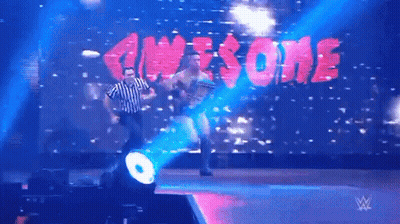 Referee On Stage In Front Of Awesome Screen GIF
