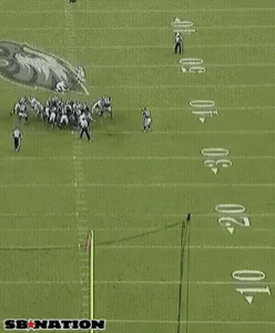 Referee Standing in Front of Eagles Sign