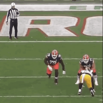 Referee Watching Two Football Players GIF
