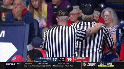 Referee With Mickey Mouse Ears Talks To Another Referee GIF