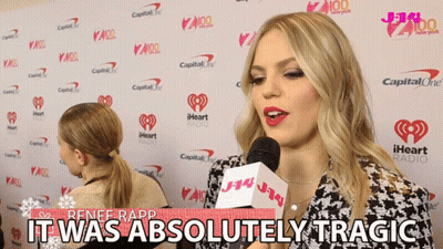 Renee Rapp Says It Was Absolutely Tragic In Front Of A Wall Of Iheart Radio Logos GIF