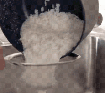 Rice Poured From Pot Into Strainer GIF