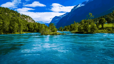 River Flowing Through Mountains With Trees GIF