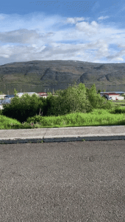 Road With Mountain And Buildings GIF