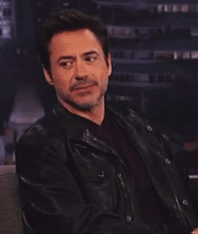 Robert Downey Jr. Is Wearing A Black Leather Jacket And A Red Shirt GIF