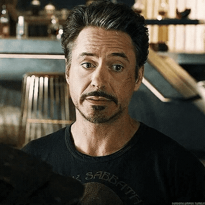 Robert Downey Jr. Is Wearing A Black Shirt That Says Sabbath On It . GIF