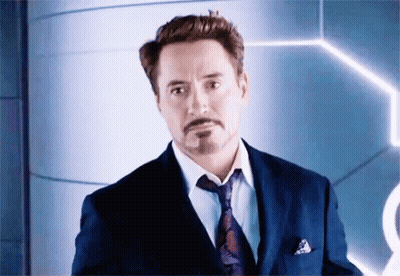 Robert Downey Jr. Is Wearing A Suit And Tie And Looking At The Camera . GIF