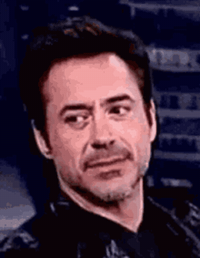 Robert Downey Jr. Making Funny Face In Black Shirt And Tie GIF