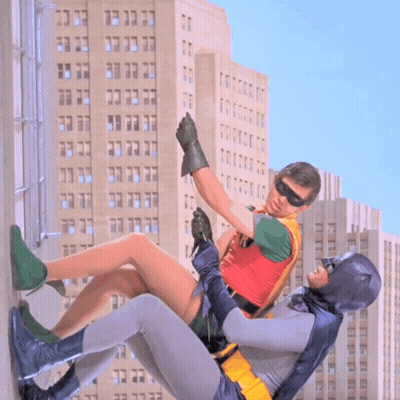 Robin And Batman Fighting In Front Of Building GIF