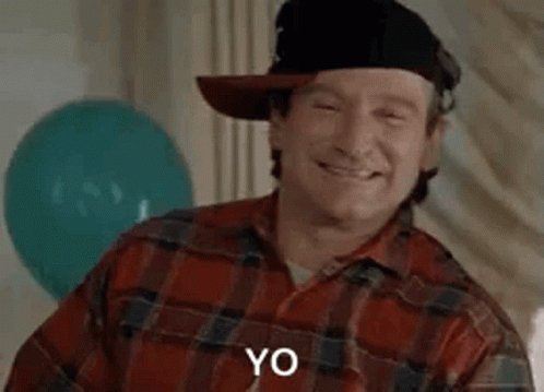 Robin Williams Is Wearing A Cowboy Hat And A Plaid Shirt And Says Wazzup . GIF