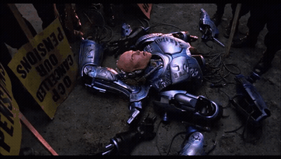 Robot Laying In Front Of Yellow Box Saying OCR GIF