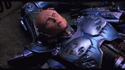 Robot Laying On Ground With Yellow Box GIF