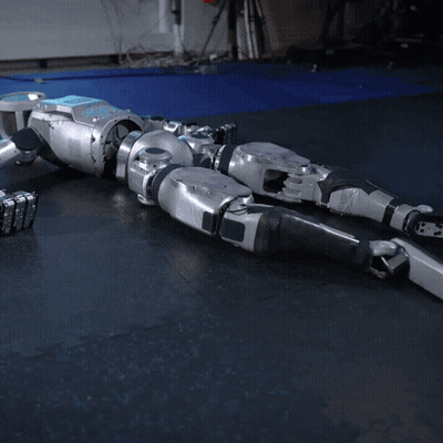 Robot Lying On Black Mat GIF
