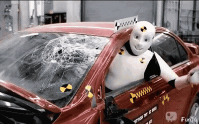 Robot Sitting In Car With Smashed Windshield GIF
