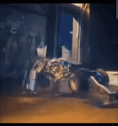 Robot Sitting In Front Of Building In Video Game GIF
