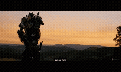 Robot Standing In Field At Sunset GIF
